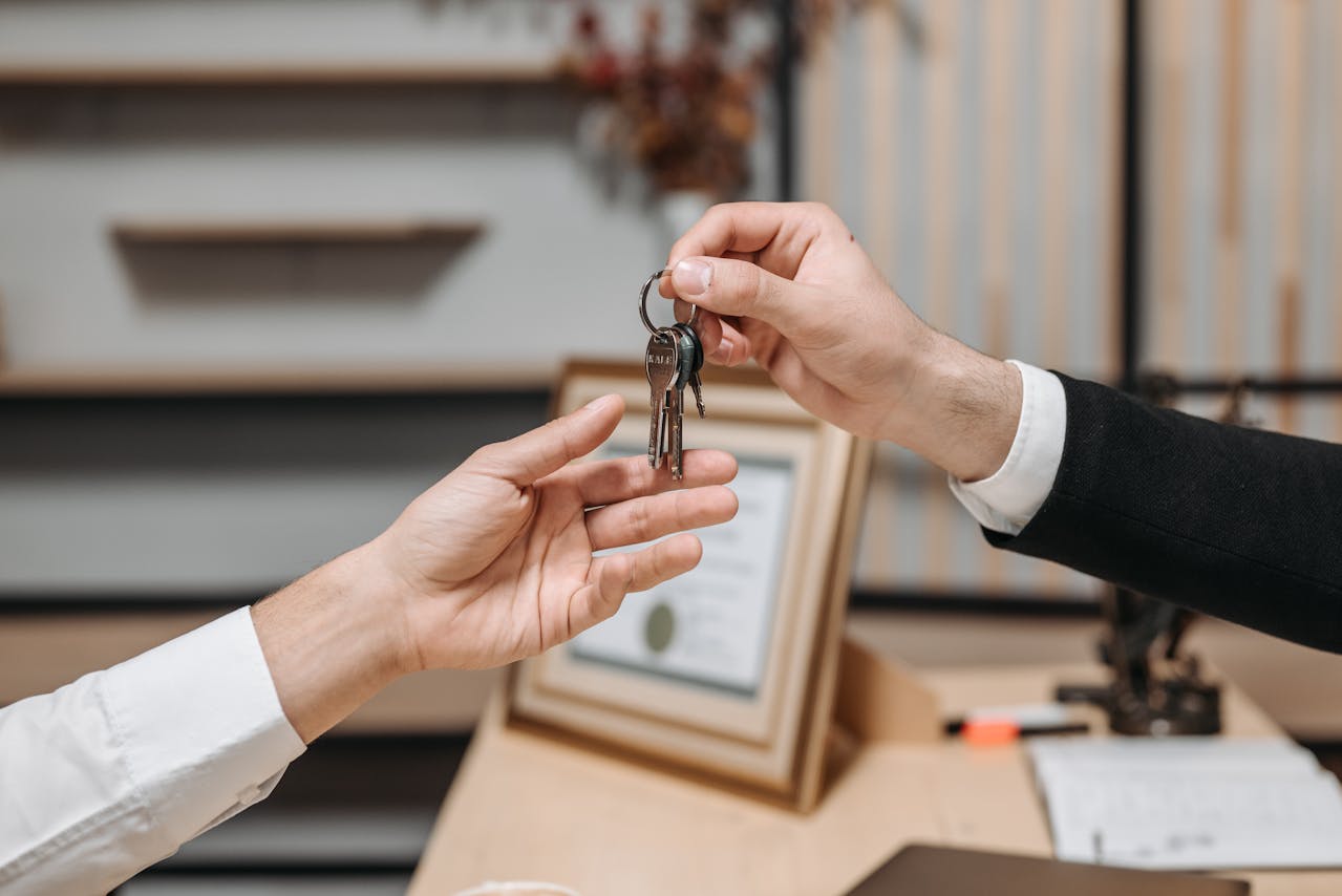 one person handing keys to another person