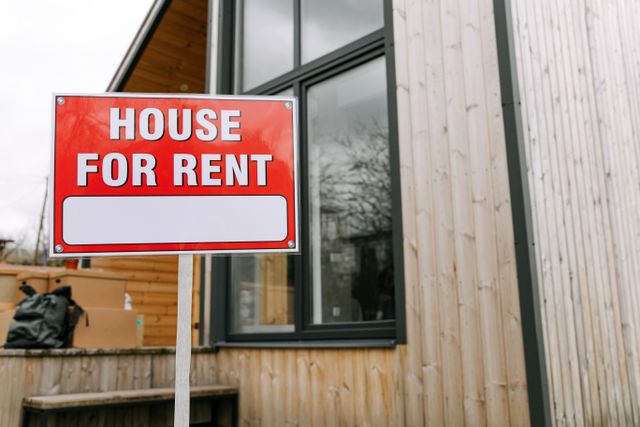 a home with a “house for rent” sign