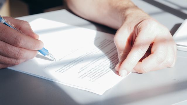 a person signing a document